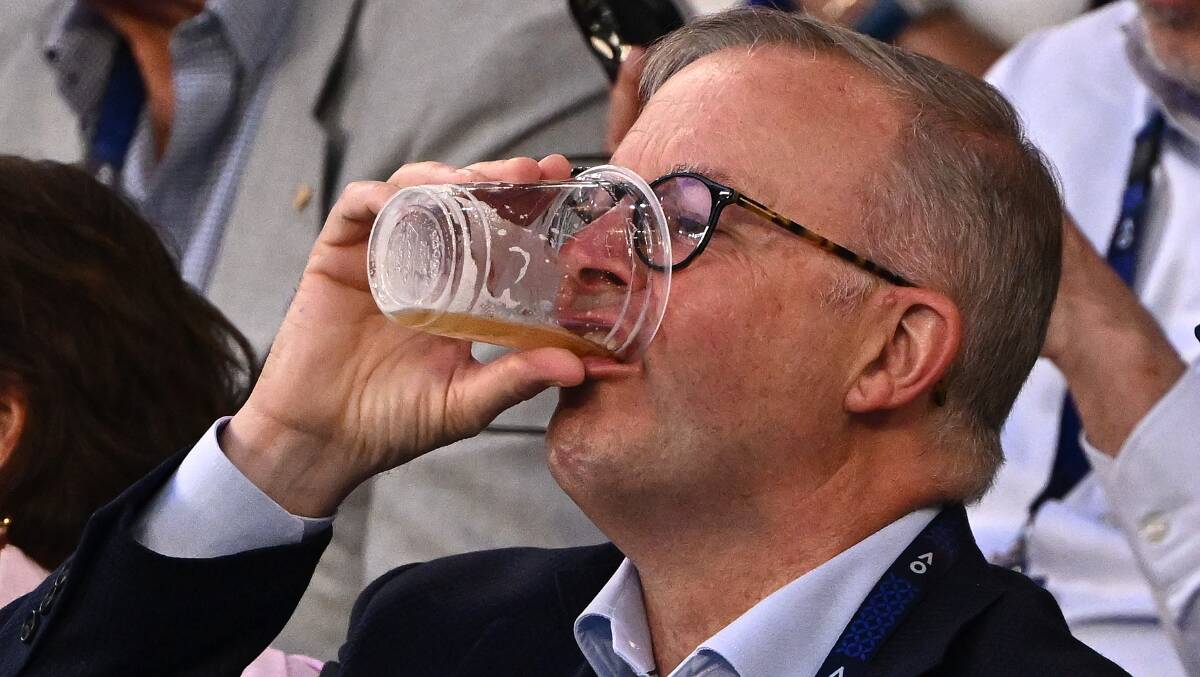 Prime Minister Anthony Albanese has a beer at the Australian Open. Picture Getty Images 