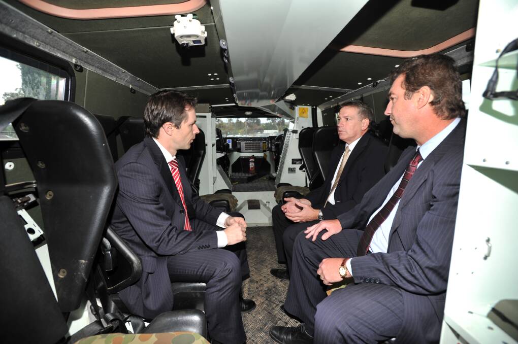 Pictured in 2010, then Minister for Defence Material Jason Clare visits Thales in Bendigo and sits inside a Bushmaster with Chris Jenkins (then Thales Australia CEO) and Ian Irving (then Land Thales Australia vice president). Picture: ALEX ELLINGHAUSEN
