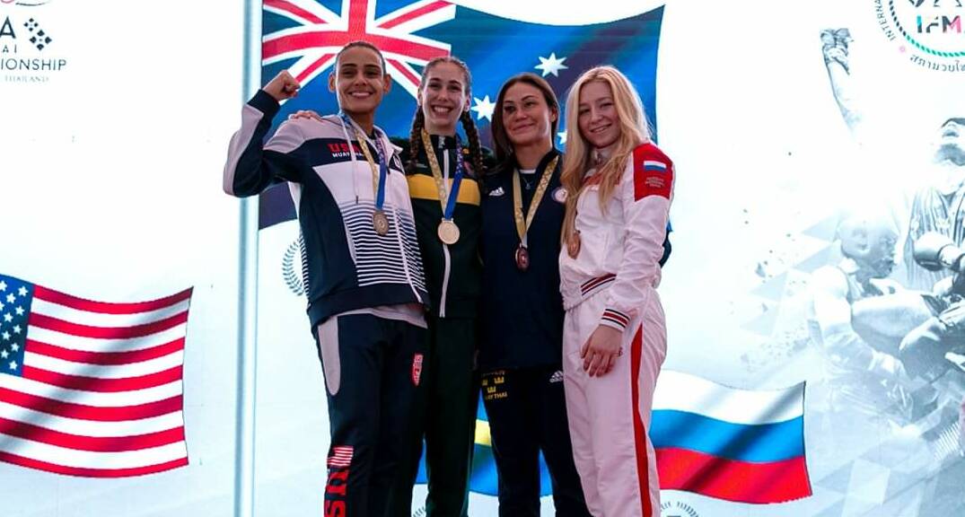Zoe Putorak stands atop the podium after winning gold at the IFMA Muay Thai world championships. Picture: Anthony Manning 