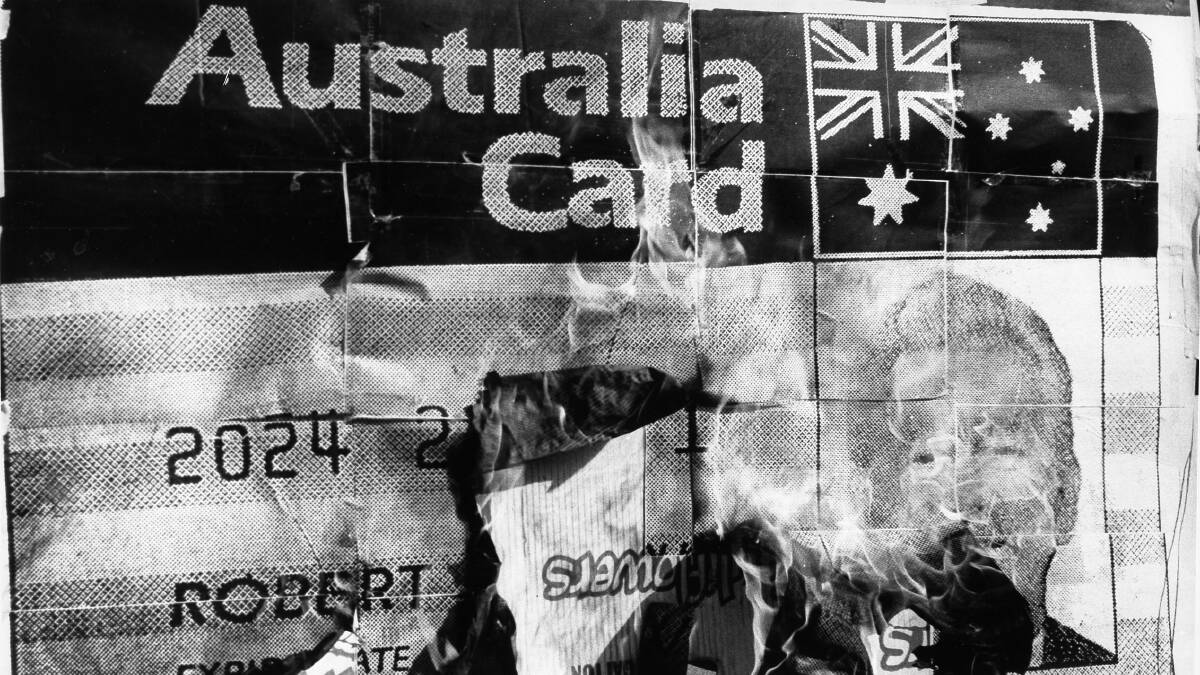 A replica of the Australia Card featuring Bob Hawke is burned by students in Sydney during a demonstration in 1987. Picture: Elizabeth Dobbie