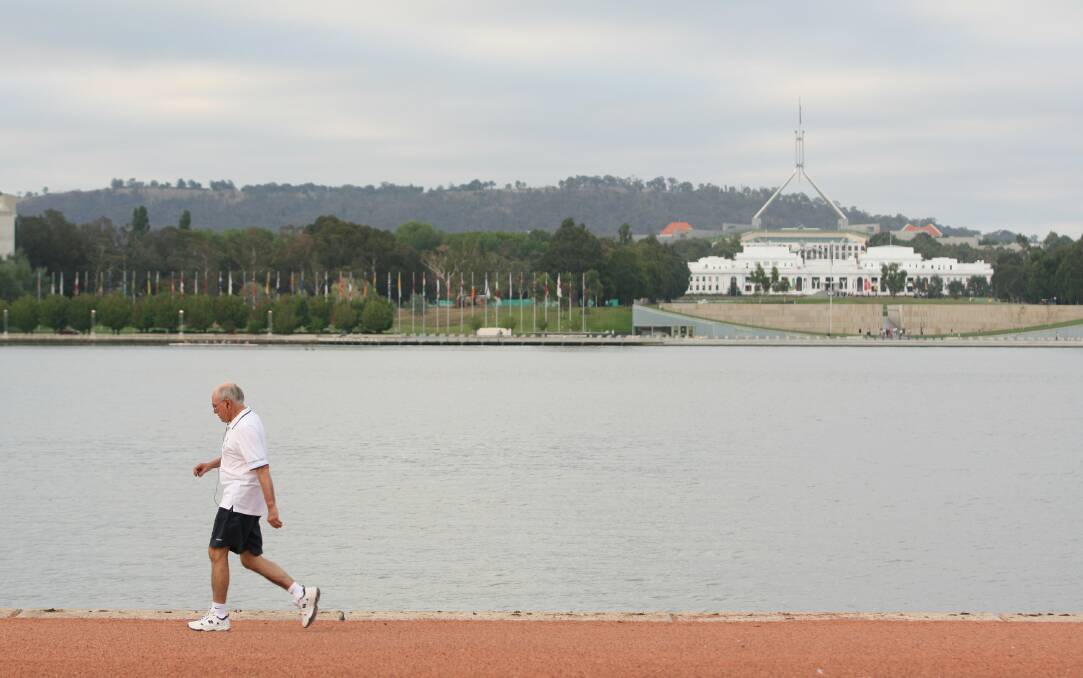 Prime Minister John Howard in 2007 walking clockwise around the lake. Picture: Andrew Sheargold