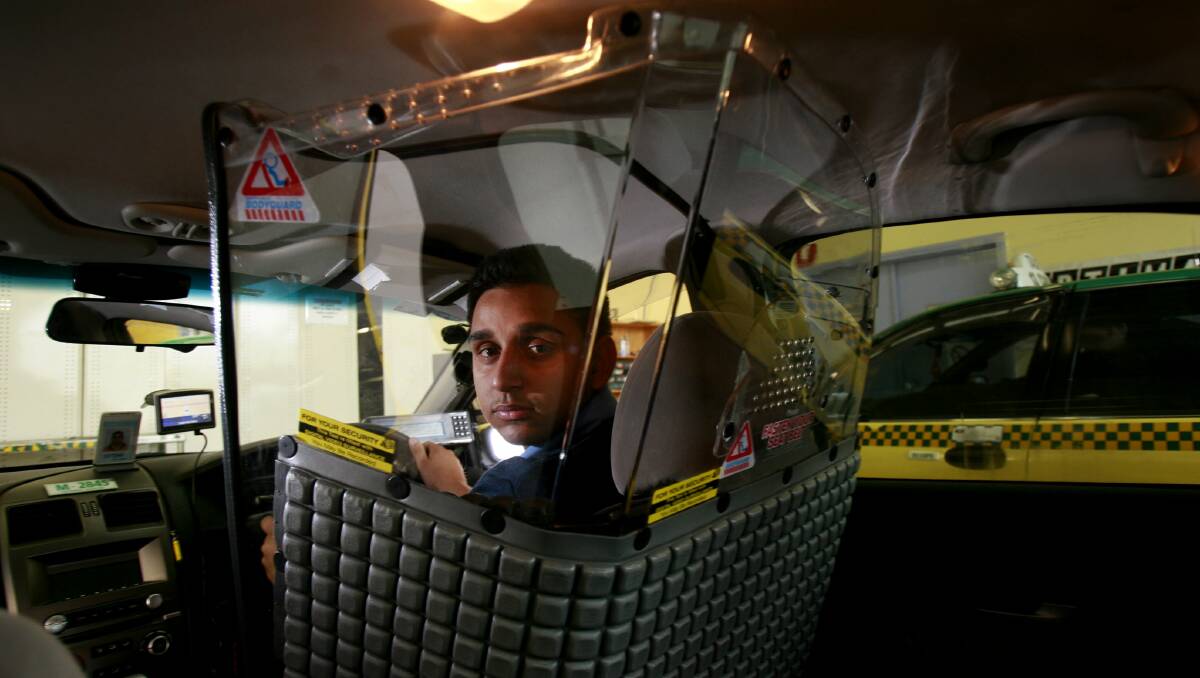 In Melbourne, taxi driver Amrinder Singh Brar is protected by a security screen. Picture Michael Clayton-Jones