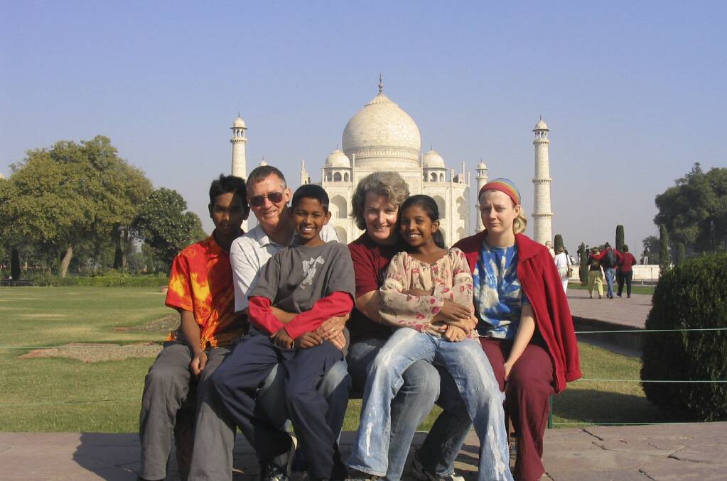 Julia Rollings, centre, and husband Barry, second from left, with family members in India. Julia Rollings has been named the ACT's 2020 local hero of the year. 