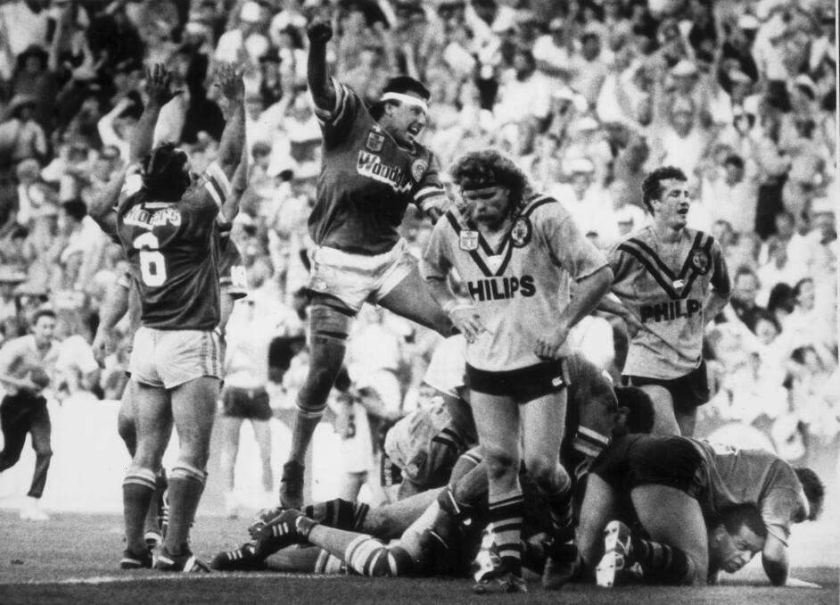 Raiders legend Laurie Daley celebrates John Ferguson's try that sent the game into extra time.