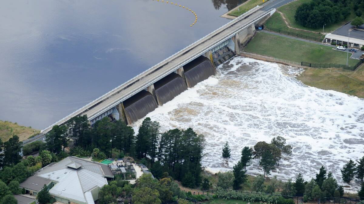 Water pours from Scrivener Dam in December 2010 as three floodgates open. Picture: Andrew Sheargold