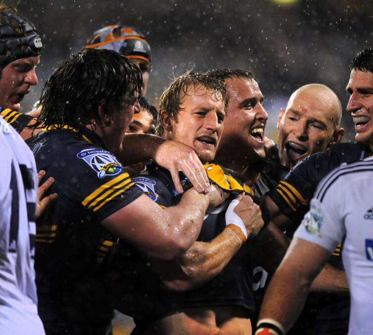 Patrick Phibbs, centre, clutches Shawn Mackay's name on his chest after scoring the winning try against the Cape Town Stormers in 2009.