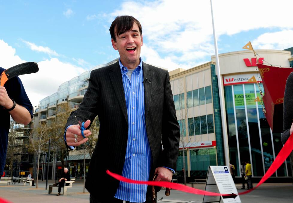 
Tim Ferguson snipping the ribbon at the plaque of the Doug Anthony Allstars in Petrie Plaza in 2012. Picture: Melissa Adams