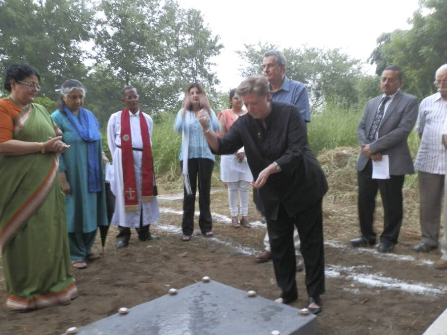 Centenary of Canberra creative director Robyn Archer sprinkles water from Lake Burley Griffin onto the grave of Walter Burley Griffin at a ceremony in Lucknow, India in 2012. Picture: Supplied