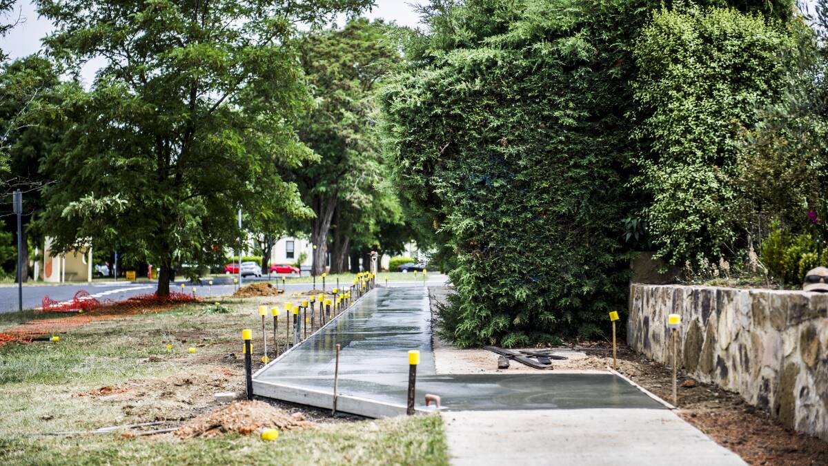A new concrete footpath is poured to go around the hedge alone Cooreen Street, Braddon in December 2012. Picture: Rohan Thomson.