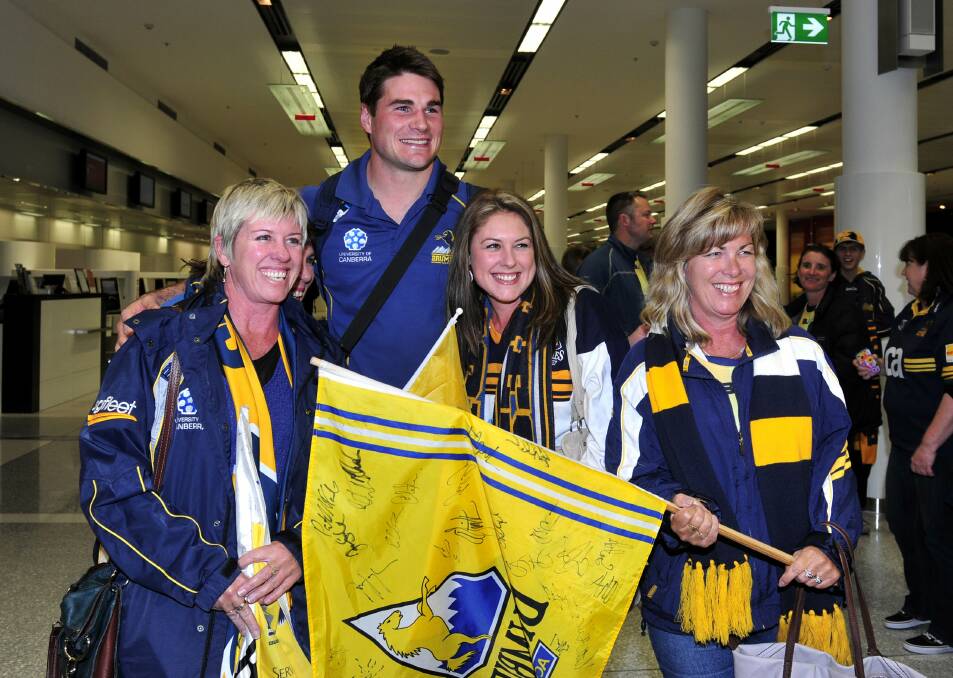 Brumbies fans greeting players at the airport during the 2013 charge. Picture: Melissa Adams