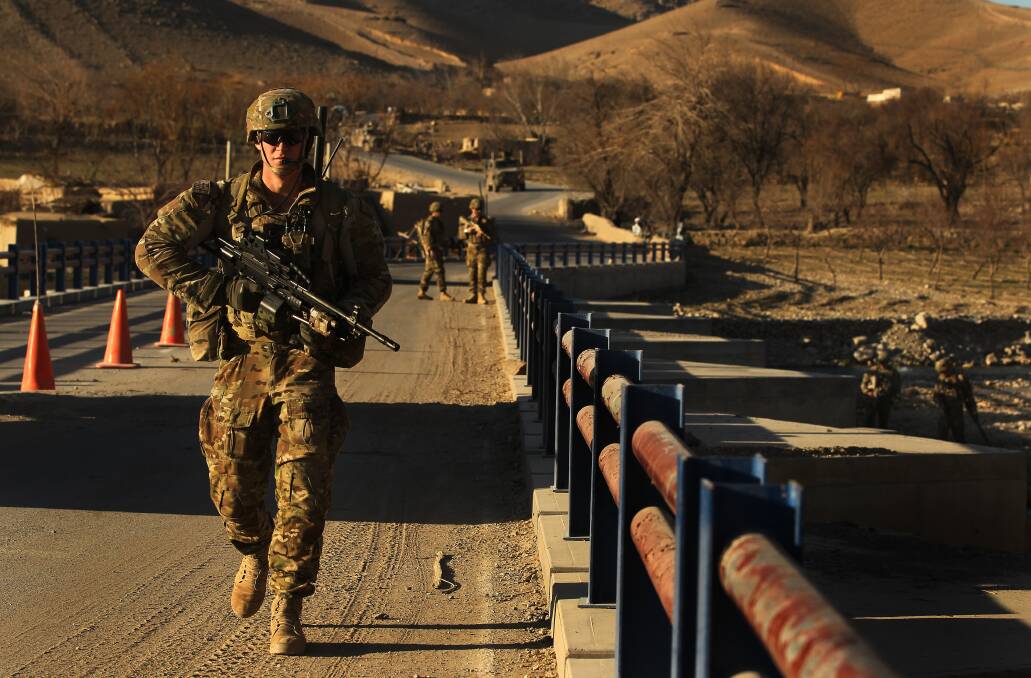 Australian soldiers patrol a bridge in Uruzgan Province, Afghanistan in 2013. Picture: Kate Geraghty
