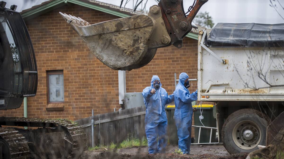 Workers demolish a Mr Fluffy home in Farrer in 2014. Picture: Rohan Thomson