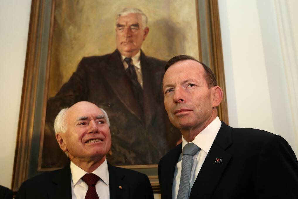 Former prime ministers John Howard (left) and Tony Abbott in front of a picture of Liberal Party founder Sir Robert Menzies. Picture: Alex Ellinghausen
