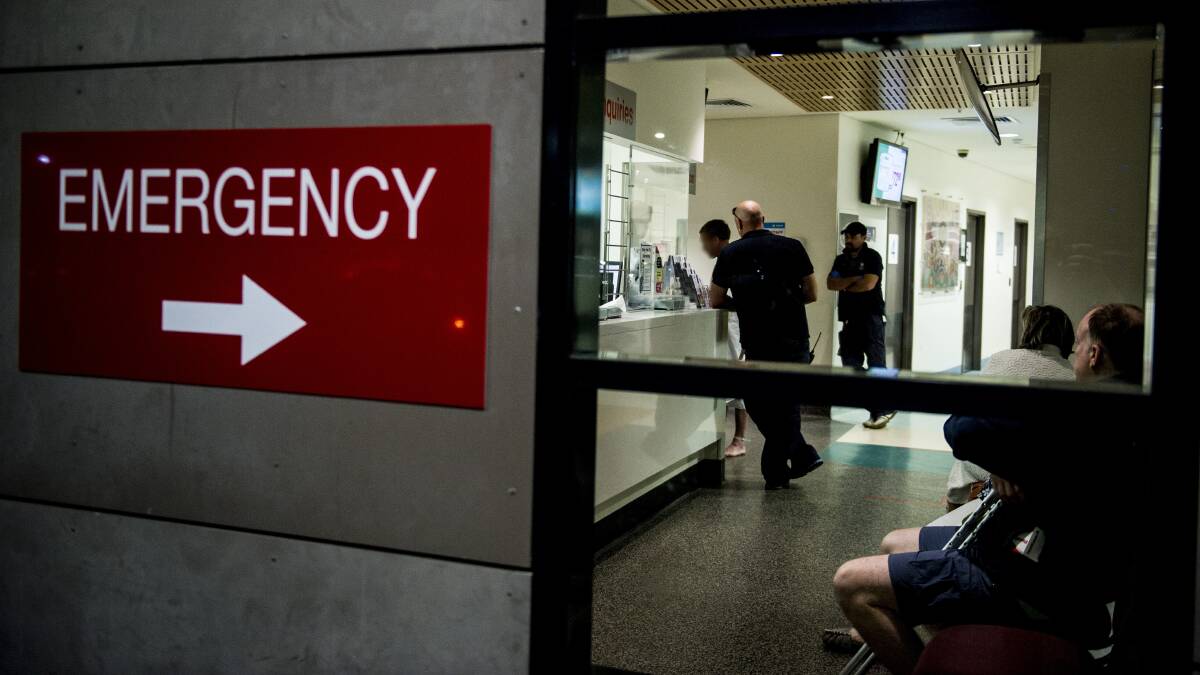Security staff help an intoxicated male leave the Emergency department at Calvary Hospital. Picture: Jay Cronan