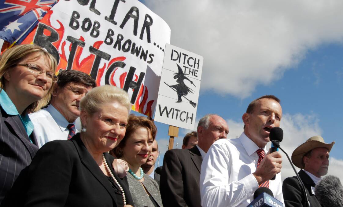 Then-opposition leader Tony Abbott addresses an anti-carbon tax rally in 2011, amid posters vilifying Gillard as prime minister. Picture: Andrew Meares