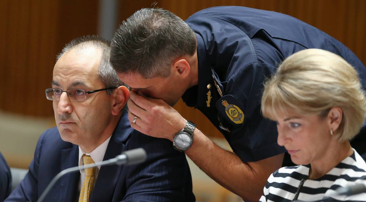 Then-Australian Border Force Commissioner Roman Quaedvlieg whispers to then-Department of Immigration and Border Protection secretary Michael Pezzullo (now Home Affairs secretary) during estimates in February 2016. Picture: Alex Ellinghausen