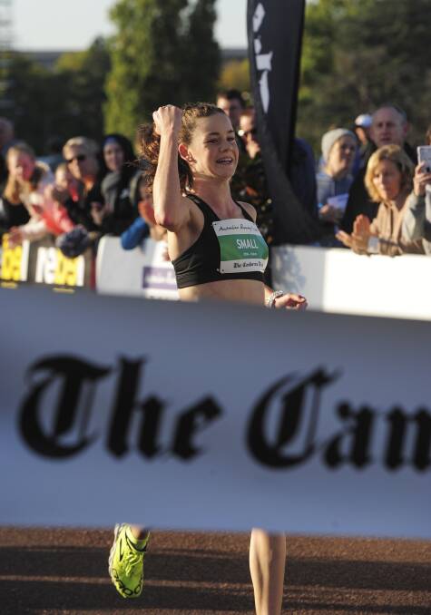 Keely Small crosses the finish line to win the 2016 10-kilometre Canberra Times fun run. Picture: Graham Tidy