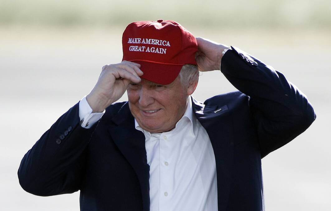 Then Republican presidential candidate Donald Trump wears his "Make America Great Again" hat in 2016.