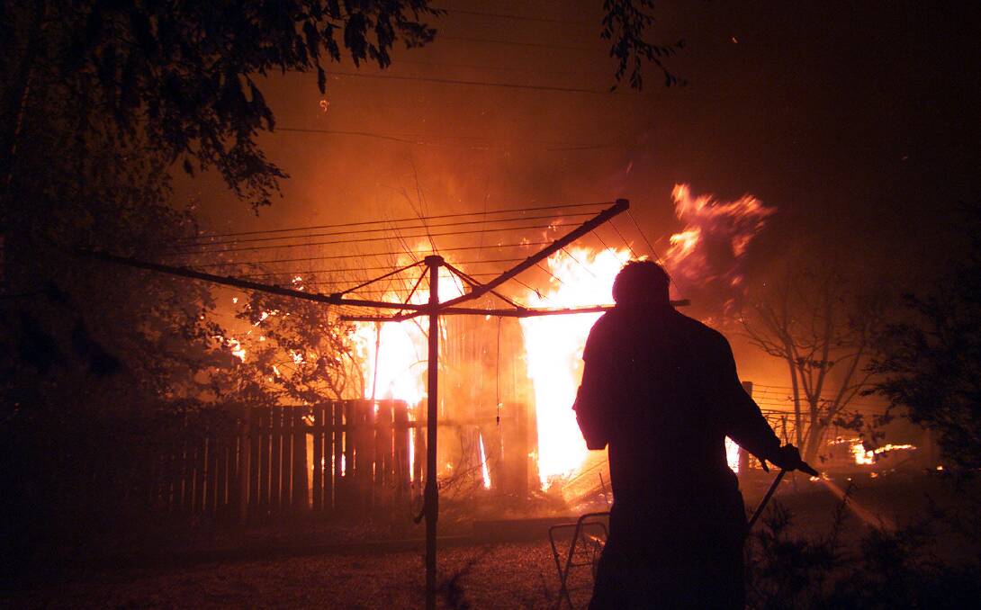 Smoke and flame turned the day into night in a backyard in Duffy, about 4pm on Saturday, January 2003. Picture: Pat Scala