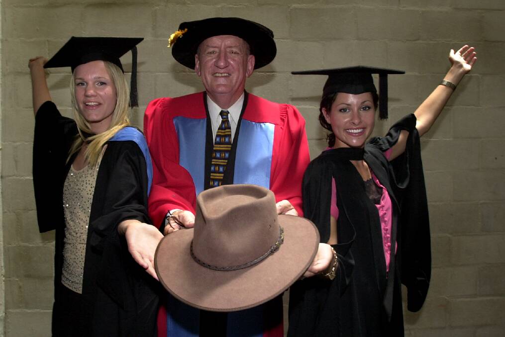Tim Fischer, awarded an honorary degree from the Australian National University in 2005, with graduating students Joanna Orzeszko,and Sam McCoutir. Picture: Melissa Adams.