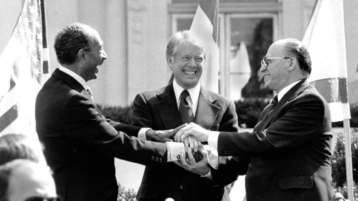 Egyptian President Anwar Sadat, US President Jimmy Carter and Israeli Prime Minister Menachem Begin after signing the peace treaty between Egypt and Israel in 1979. 