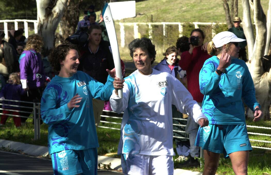 Heather McKay was the first torch bearer in the ACT, who ran the flame down the Federal Highway. Picture: Kym Smith