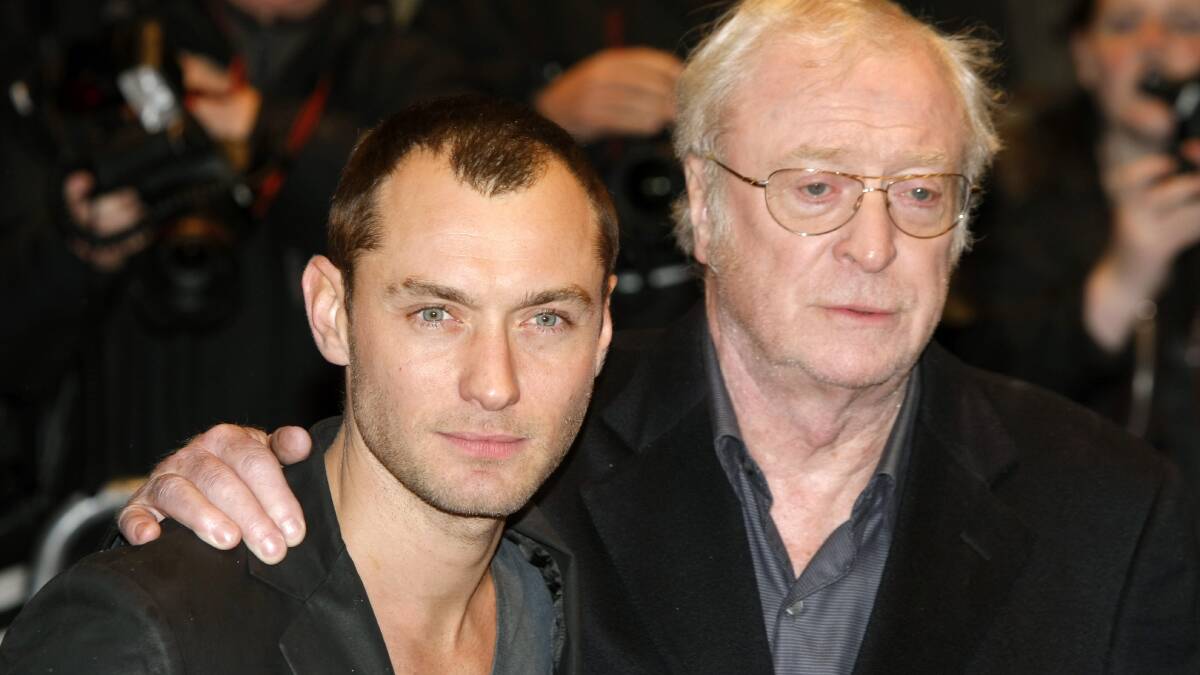 British actors Jude Law, left, and Michael Caine pose for photographs as they arrive for the UK premiere of their film Sleuth at a West End cinema in London, Sunday Nov. 18, 2007. (AP Photo/Matt Dunham)
