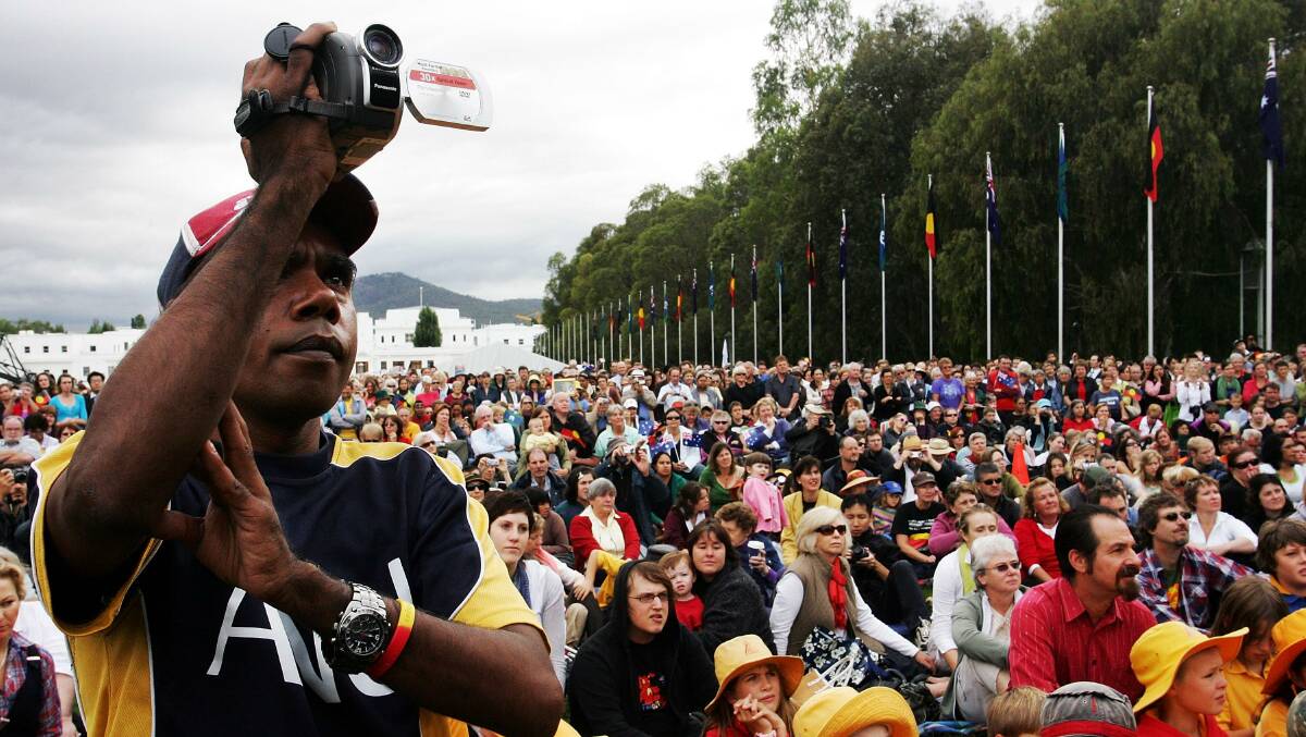 Thousands of people watched television screens on the Parliament lawns as Australian Prime Minister Kevin Rudd delivered the historic apology in 2008. Picture: Getty Images
