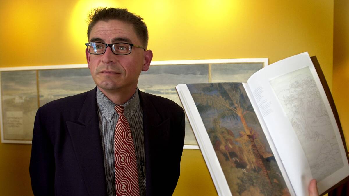 Christopher Vernon with one of Marion Mahony Griffin's renderings from the prize-winning Canberra plan at the National Archives of Australia in 2001. Picture: Melissa Adams