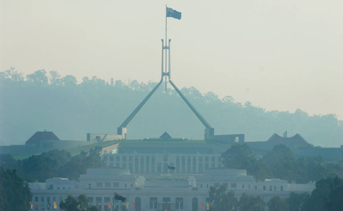Smoke from a bushfire settles over Parliament House. Picture: Marina Neil