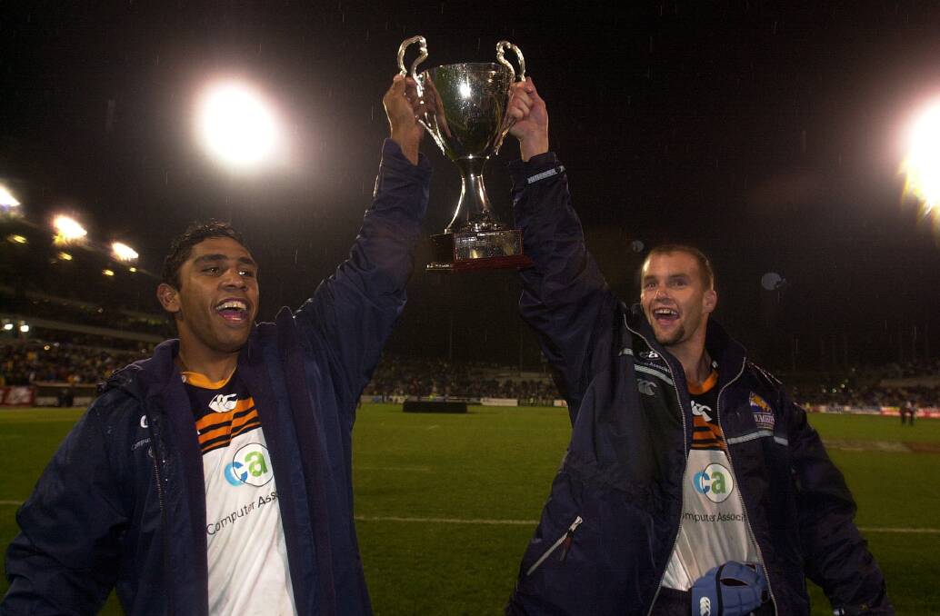 Peter Ryan, right, and Andrew Walker celebrate the 2001 Super Rugby title win. Picture: Gary Schafer