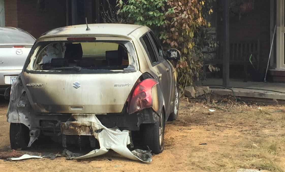 One of the cars set alight in the attack at an Isabella Plains home in 2017. Picture: Andrew Brown