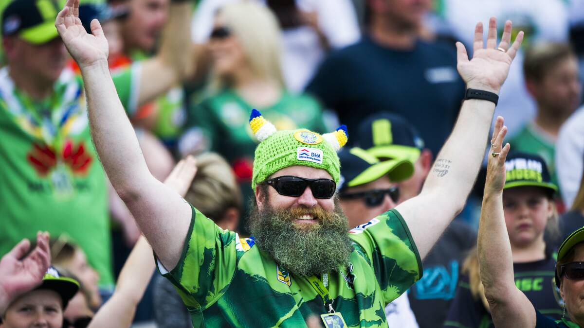 A Canberra Raiders fan takes part in the famed Viking Clap at Canberra Stadium, which all new fans need to be initiated in. Photo: Jamila Toderas