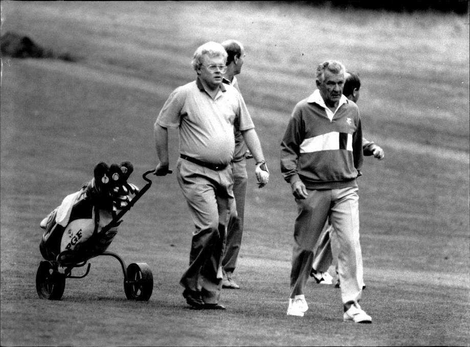Then senator Graham Richardson with prime minister Bob Hawke playing golf in 1990. Picture: Fairfax Media.