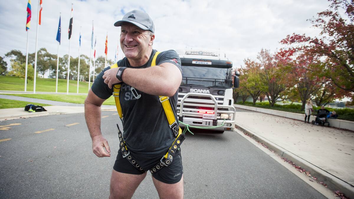 Retiring Australian Federal Police officer Grant Edwards during one of his many strongman challenges. Picture: Dion Georgopoulos