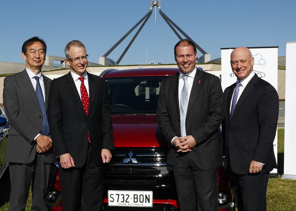 Mitsubishi chief executive Mutsuhito Oshikiri, Minister for Urban Infrastructure Paul Fletcher, then-minister for Environment and Energy Josh Frydenberg and then-AGL chief executive Andy Vesy at an electric car event in 2017. Photo: Alex Ellinghausen