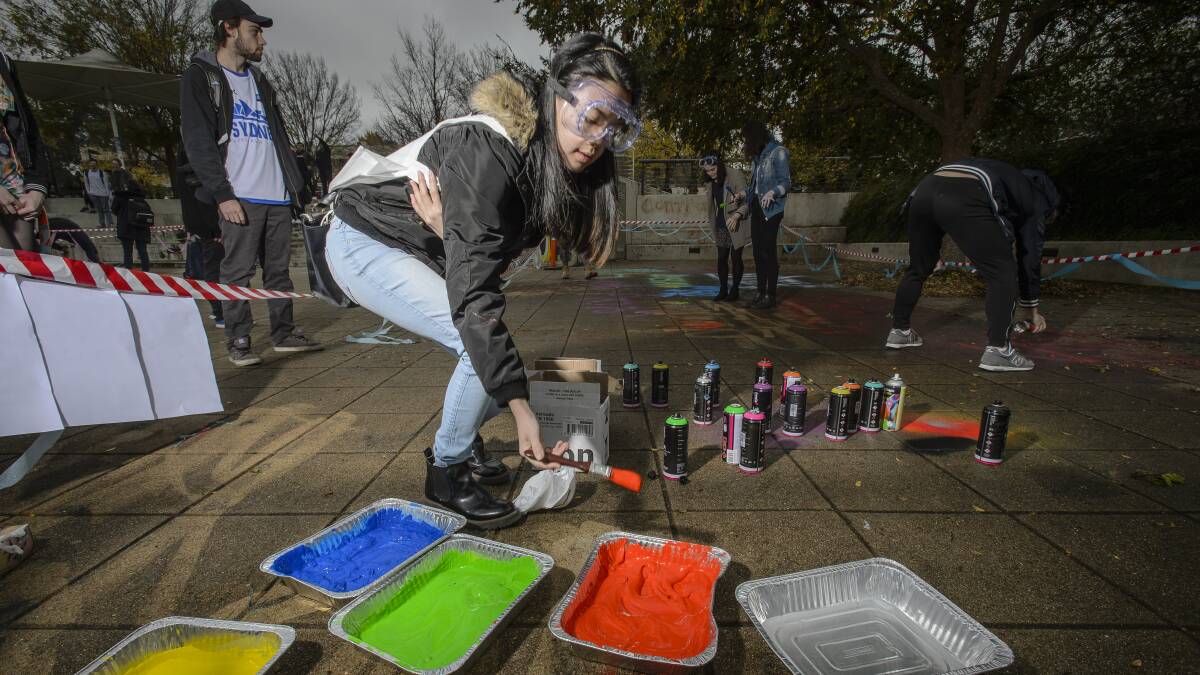 ANU students sprayed messages on the university's Union Court as a tribute before the area was closed off for demolition in 2017. Picture: Sitthixay Ditthavong