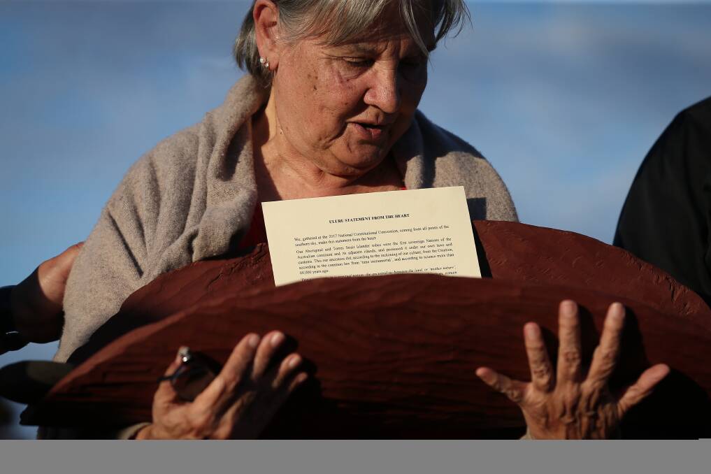 Pat Anderson from the Referendum Council with a piti holding the Uluru Statement from the Heart. Picture: Alex Ellinghausen
