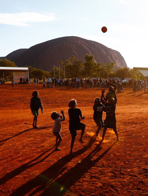 Children play footy during the closing ceremony in the Mutitjulu community of the First Nations National Convention held at Uluru in 2017. Picture: Alex Ellinghausen