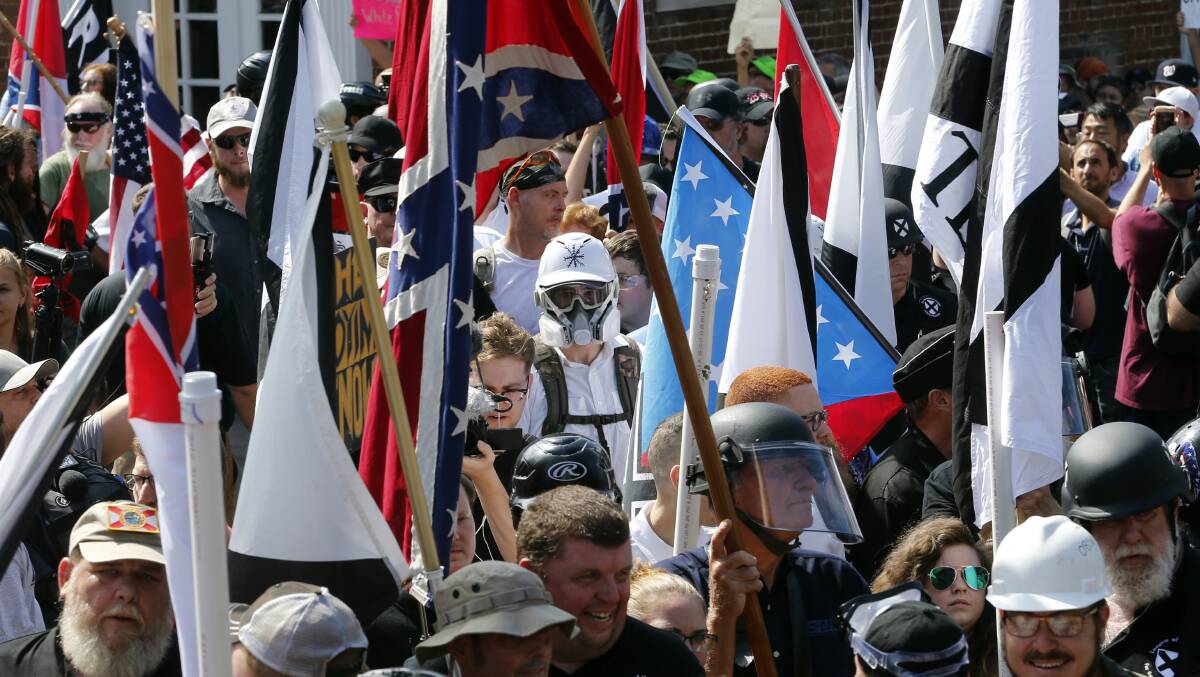 White nationalist demonstrators walk into the entrance of Lee Park surrounded by counter demonstrators in Charlottesville in 2017. Picture: AP