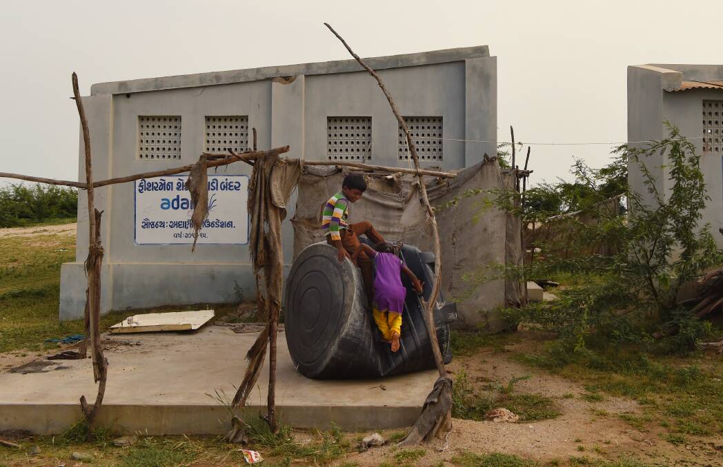 Children play near the toilet block in Gujarat Stae, India. Picture: Kate Geraghty