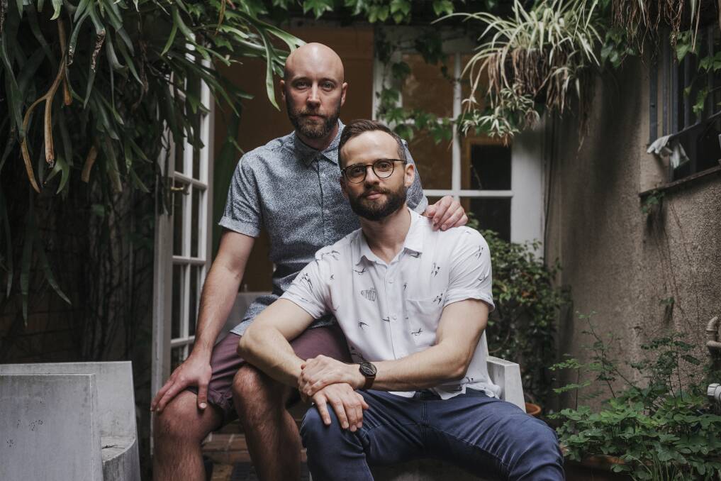 Playwright Tommy Murphy in glasses, and his partner Dane Crawford at their home in Surry Hills in 2017. Picture: James Brickwood. 