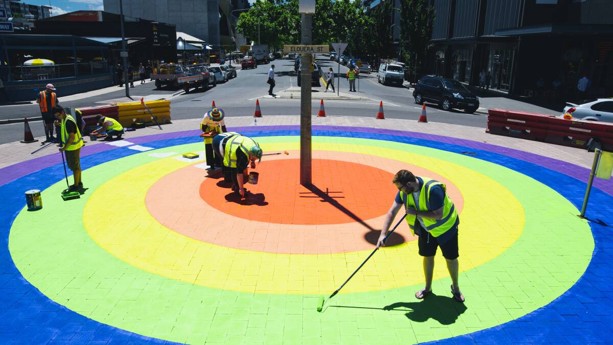 Canberra
Members of the community paint the final touches on the rainbow roundabout on the corner of Elouera St and Lonsdale St in Braddon. 