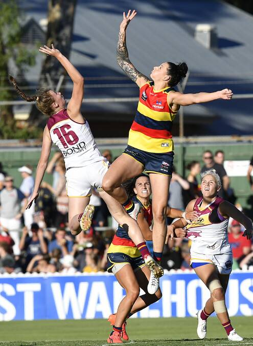 Adelaide Crow Rhiannon Metcalfe, right, contests a mark in round 1 of the AFLW on February 3, 2018. Photo: AAP