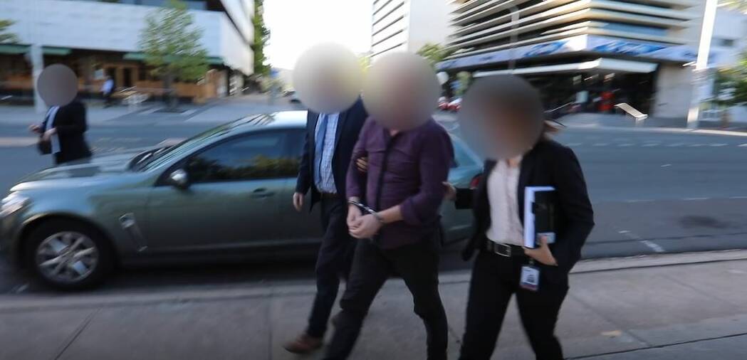 Bradley Lester Grey, who has been sentenced to more than 11 years in jail, being walked into City Police Station after his arrest. Picture: Supplied