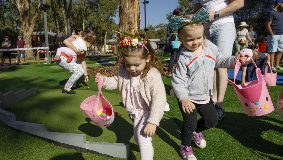 Kids scramble to collect as many eggs as they can in the Easter egg hunt. Photo: Sitthixay Ditthavong