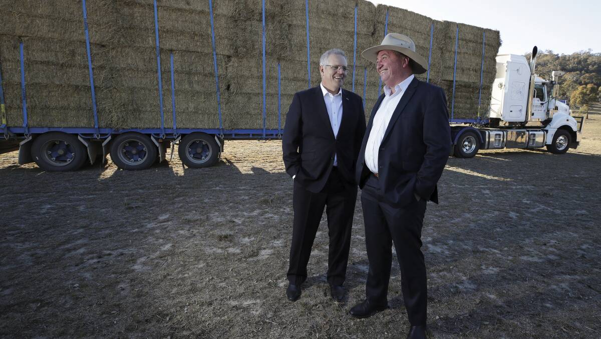 Prime Minister Scott Morrison and drought envoy Barnaby Joyce with a hay truck at Royalla. Picture: Alex Ellinghausen