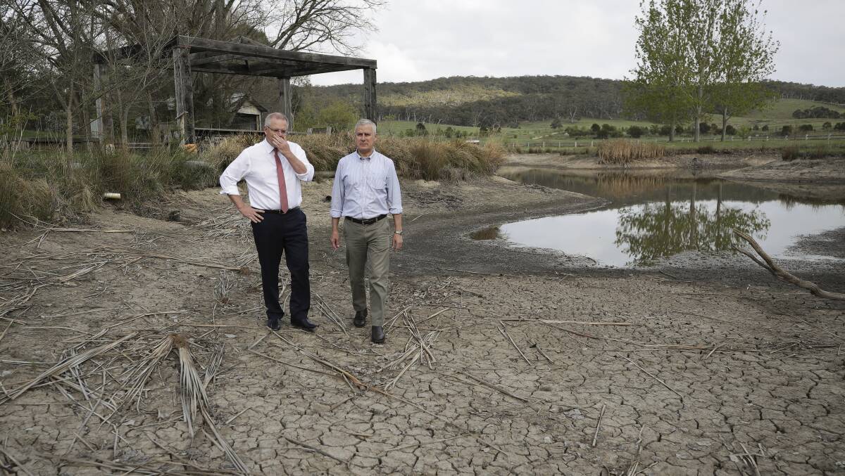 Prime Minister Scott Morrison and Deputy Prime Minister Michael McCormack at a dried-out dam in Mulloon, NSW. Picture: Alex Ellinghausen