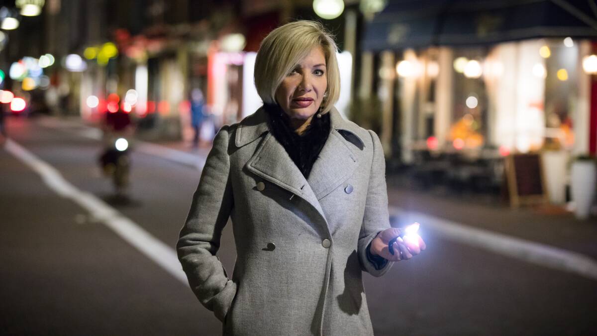 WanderSafe founder Stephenie Rodriguez with the personal safety device at night. Picture: Supplied