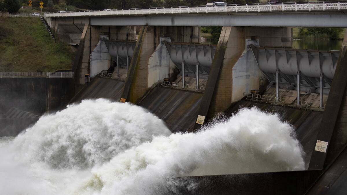 Water gushes from sluice gates at Scrivener Dam after heavy rain in 2018. Picture: Sitthixay Ditthavong